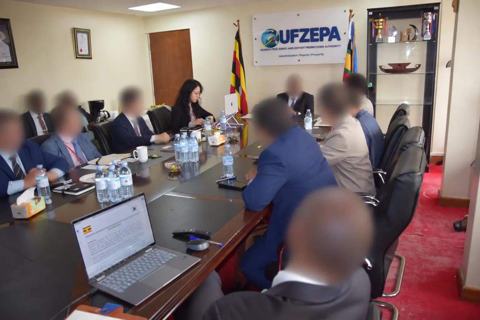 Eunji Wendy Yang meeting local institutions during a Uganda pre-feasibility study; other participants’ faces are blurred